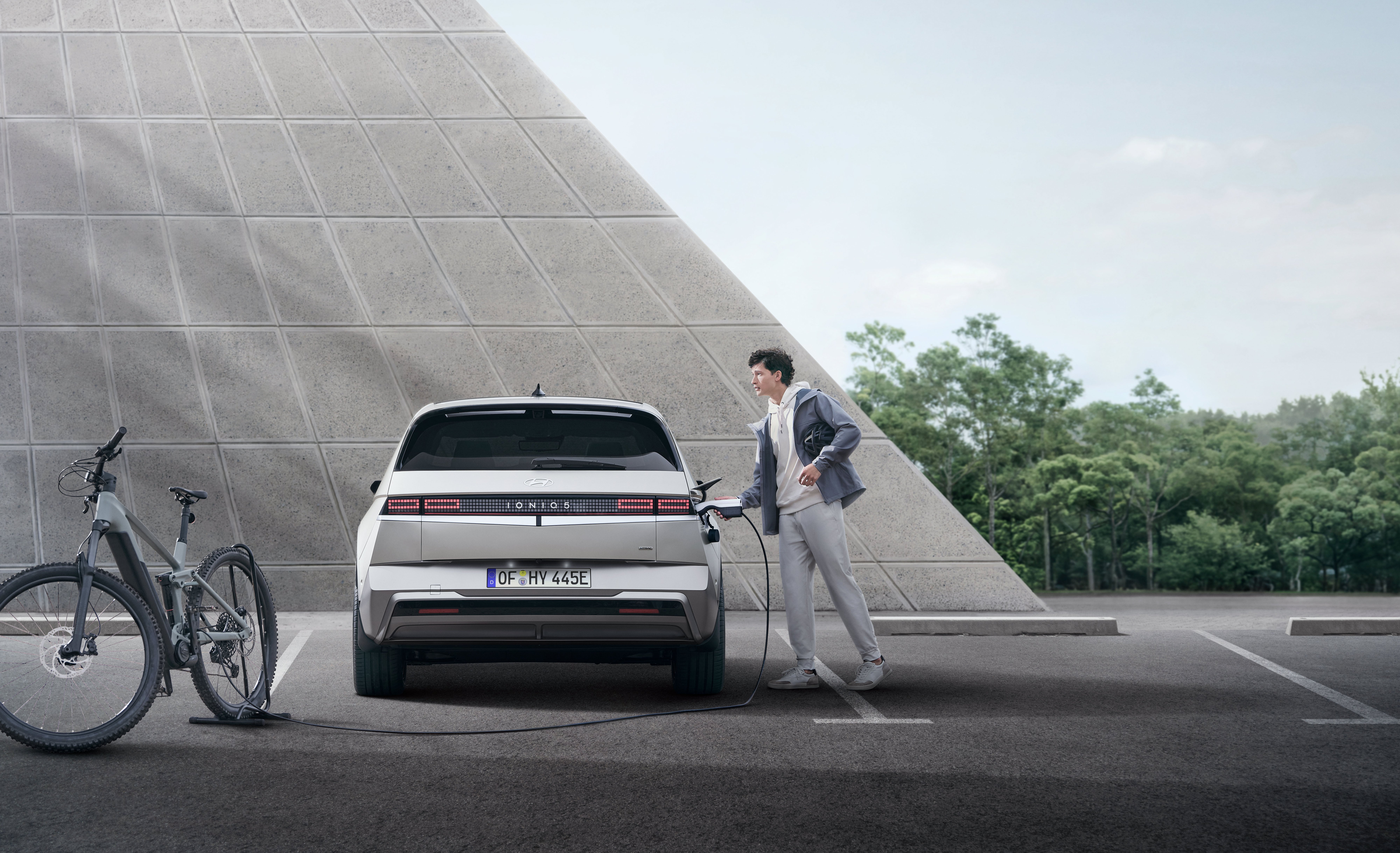 A man charging Hyundai IOINIQ 5 N Line in the public parking.